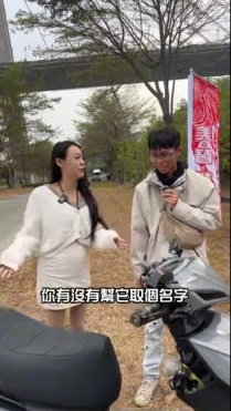 原影片約00:21實際畫面。阿奇在原片代為介紹蕊恩車業店車小灰,人物與車輛關係依受訪內容標示。